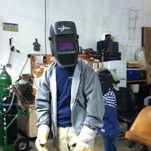 A member of the Open Bench Project wearing welding mask